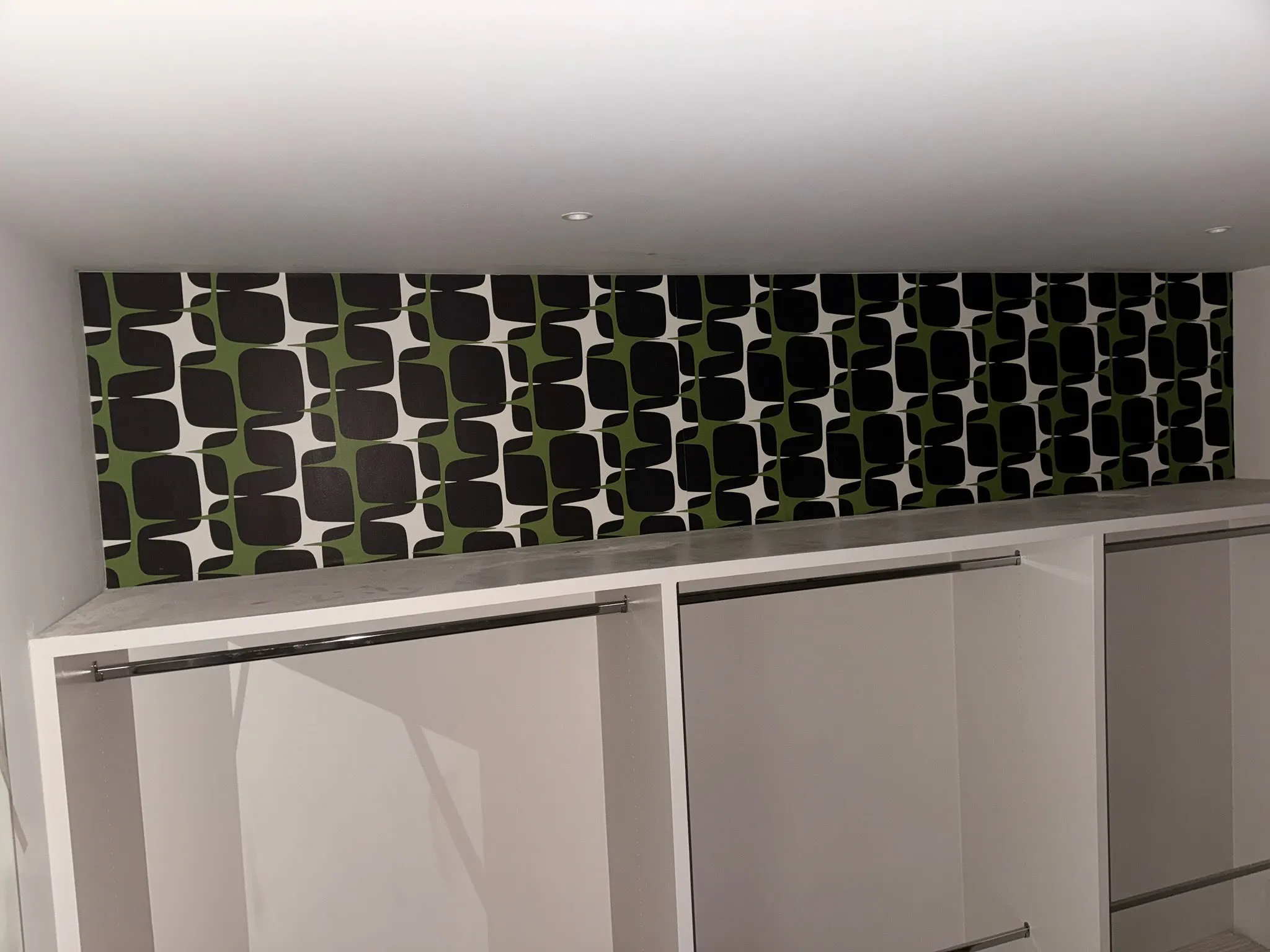 Dan Warren WallCoverings installer carefully applying wallpaper in Washington